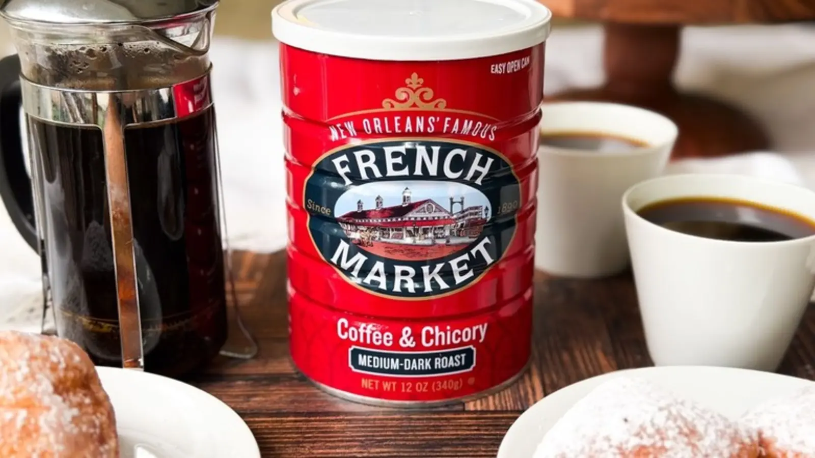 French Market Coffee & Chicory Dark Roast Ground shown in a coffee-serving or brewing setting