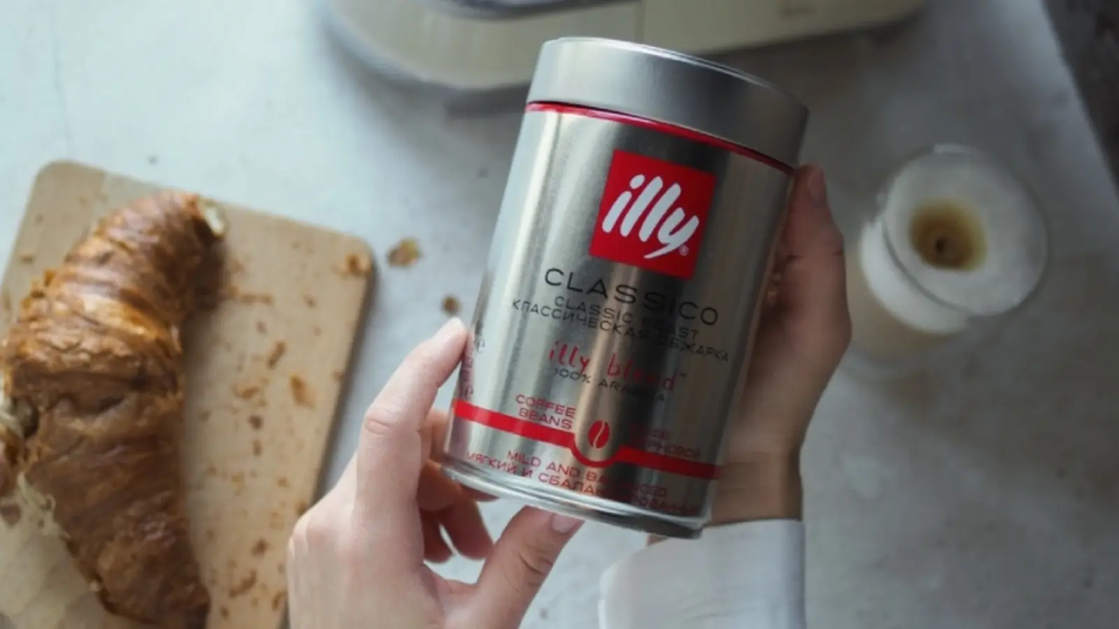 illy Classico Whole Bean, 6 × 8.8 oz cans shown in a coffee-serving or brewing setting