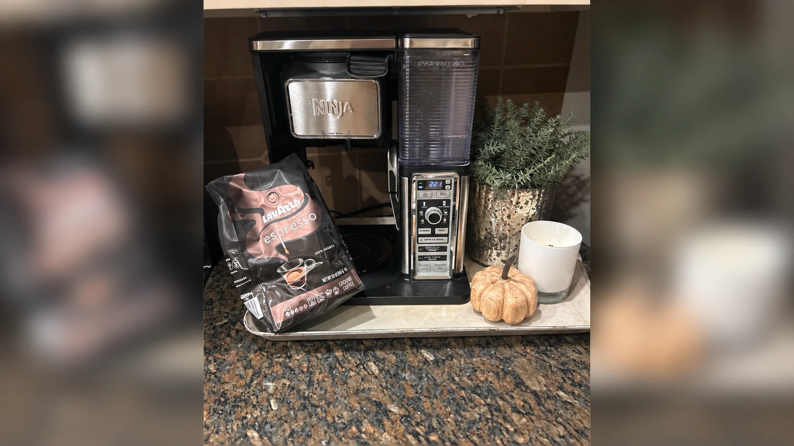 Lavazza Espresso Italiano 20 oz ground-coffee bag beside a home coffee maker