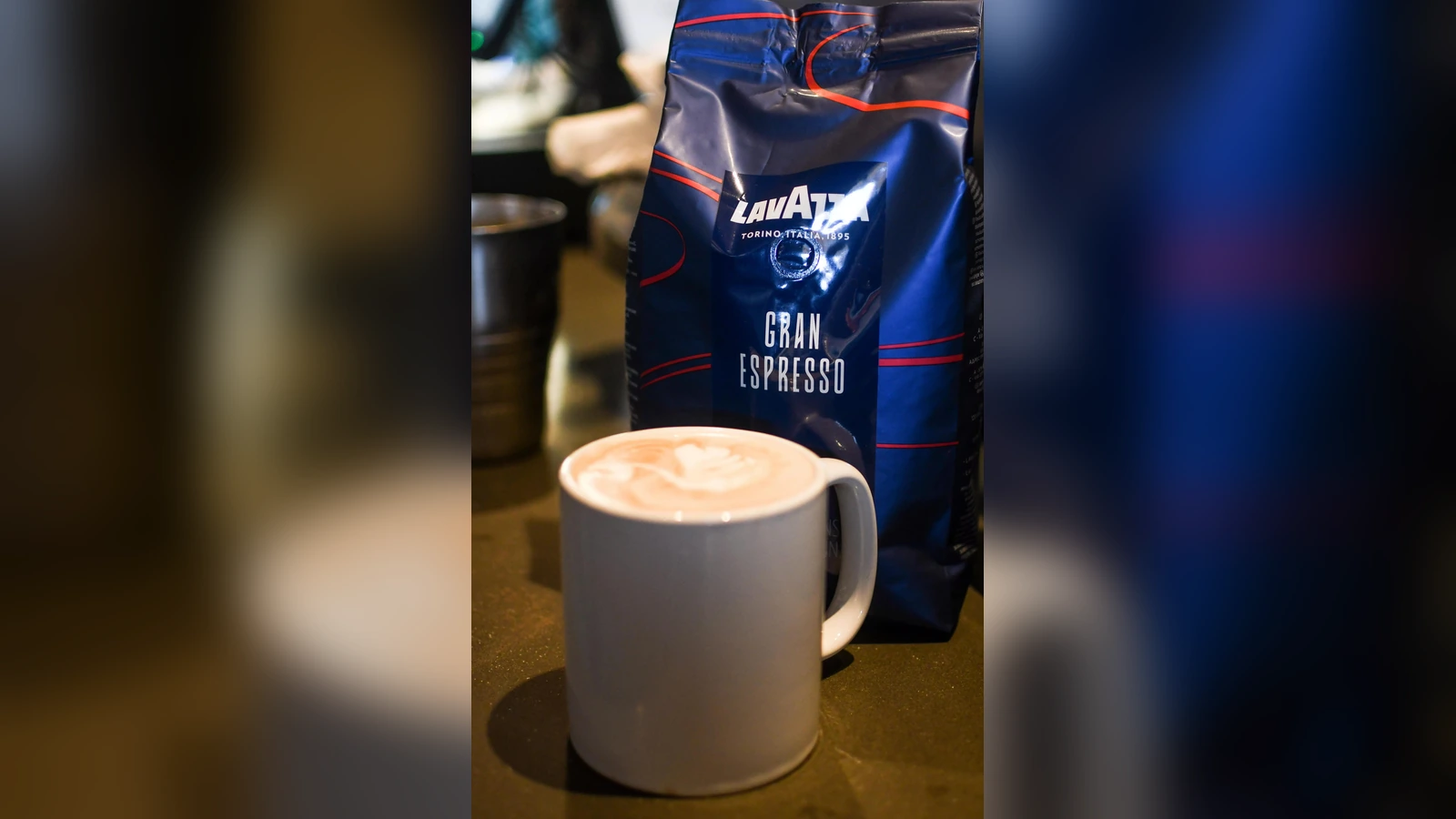 Lavazza Gran Espresso whole-bean coffee beside a prepared espresso