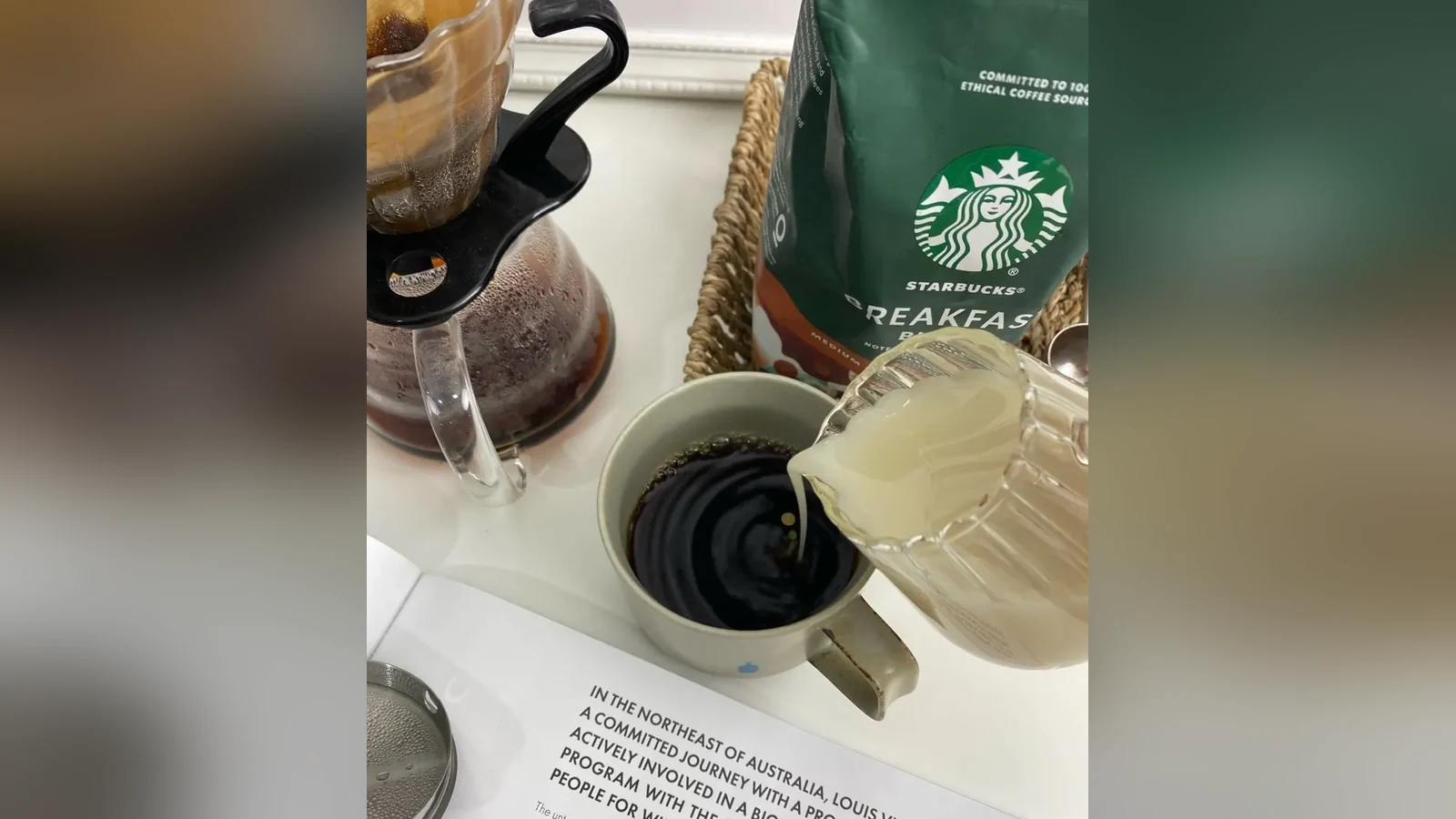 Starbucks Breakfast Blend by a home pour-over brewer while milk is poured into a cup of coffee