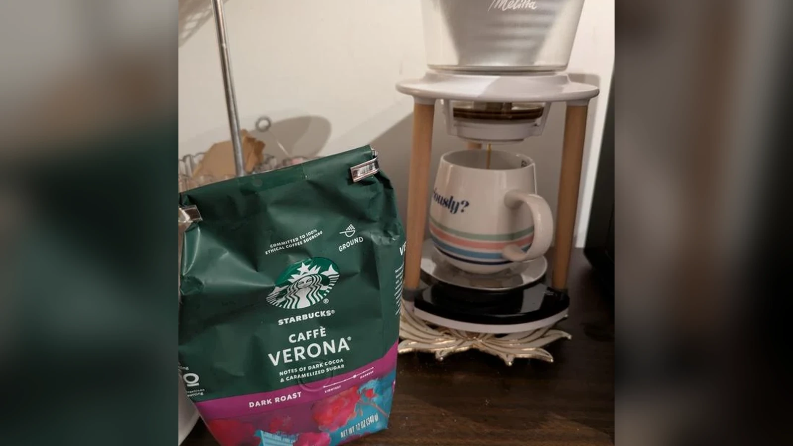 Starbucks Caffè Verona ground coffee beside a Melitta dripper brewing into a mug