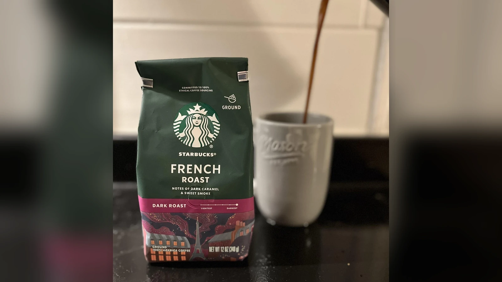 Starbucks French Roast ground coffee beside a mug being filled with coffee