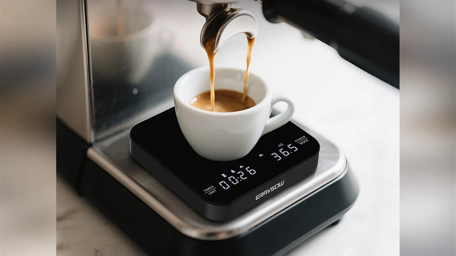 ERAVSOW K112BK scale weighing espresso in a white cup beneath a portafilter