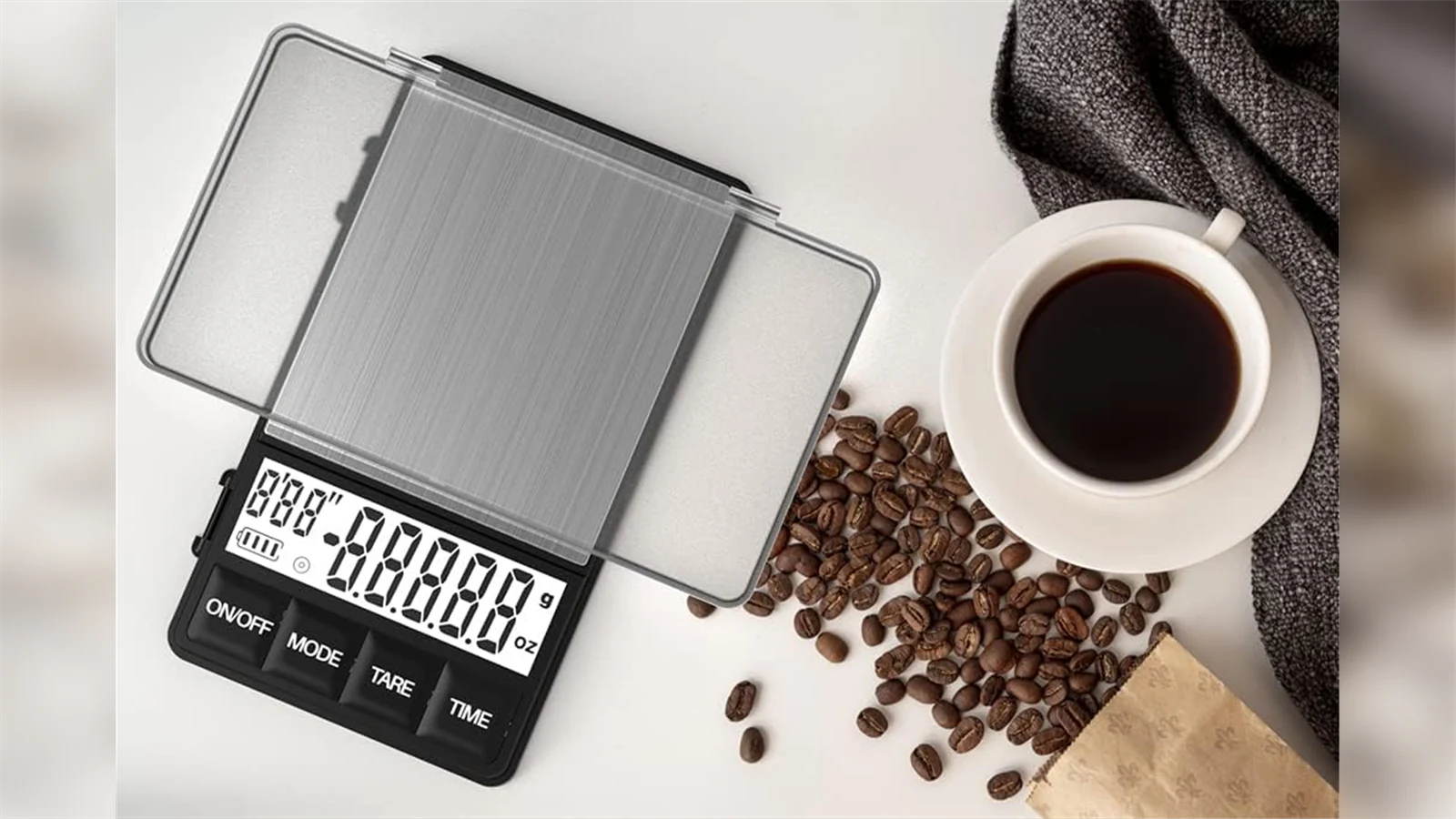 MAXUS espresso scale with its cover open beside coffee beans and a cup