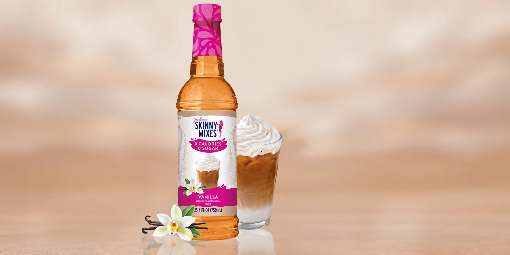 Jordan’s Skinny Mixes Vanilla bottle beside an iced coffee topped with whipped cream