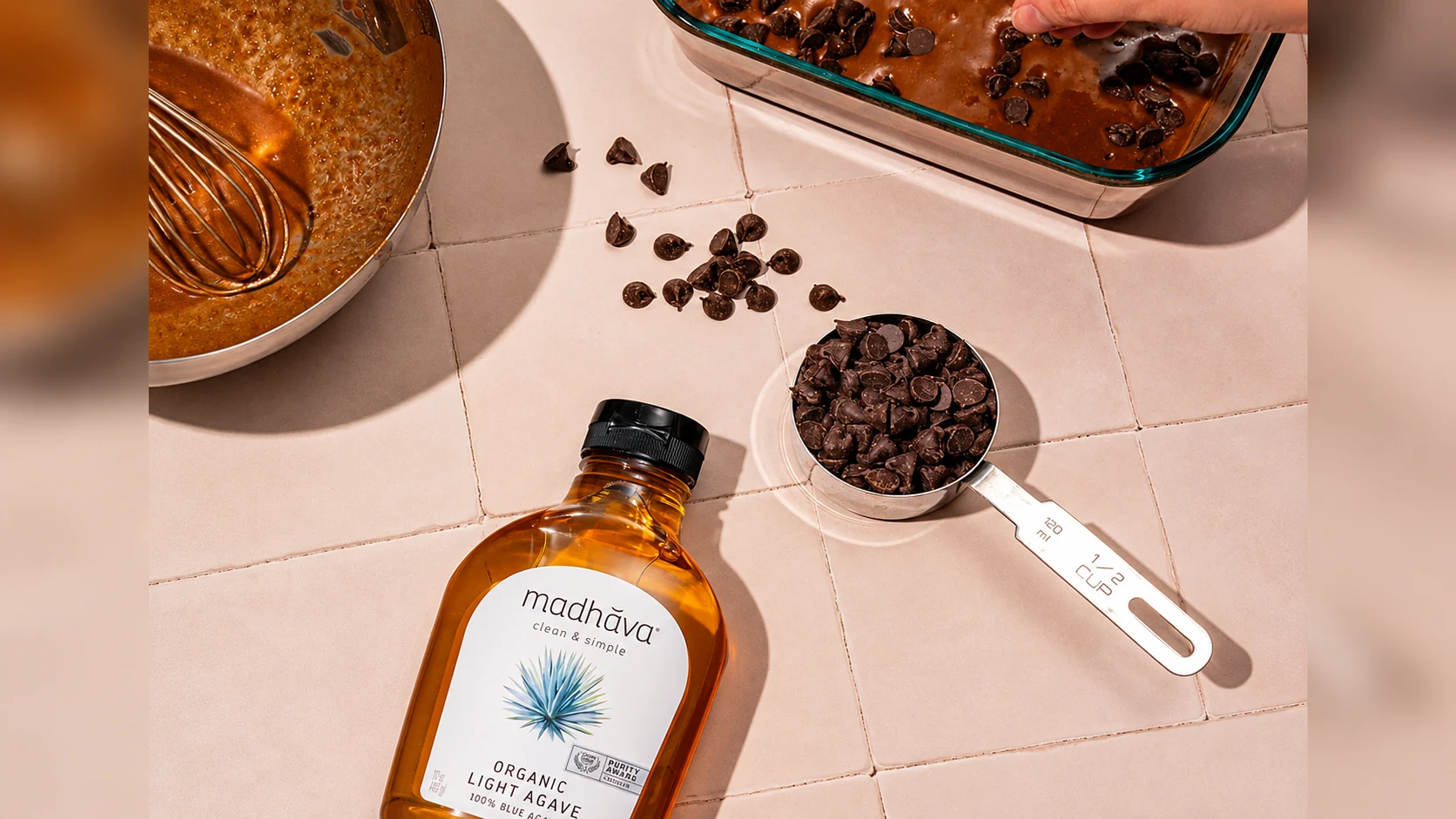 Madhava Organic Light Agave with chocolate chips and baking ingredients on a counter