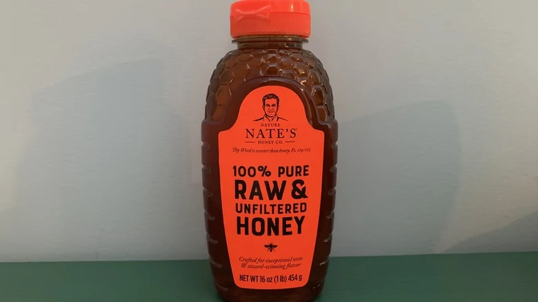 Nate’s raw and unfiltered honey bottle on a tasting table
