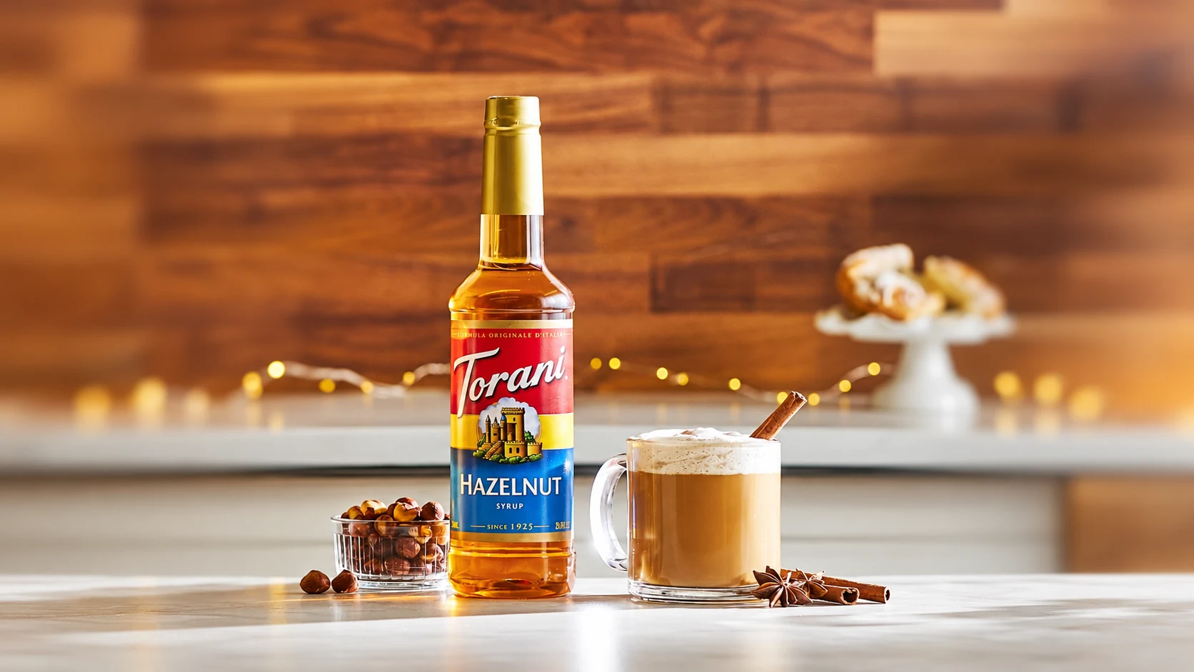 Torani Hazelnut syrup beside a prepared milk coffee
