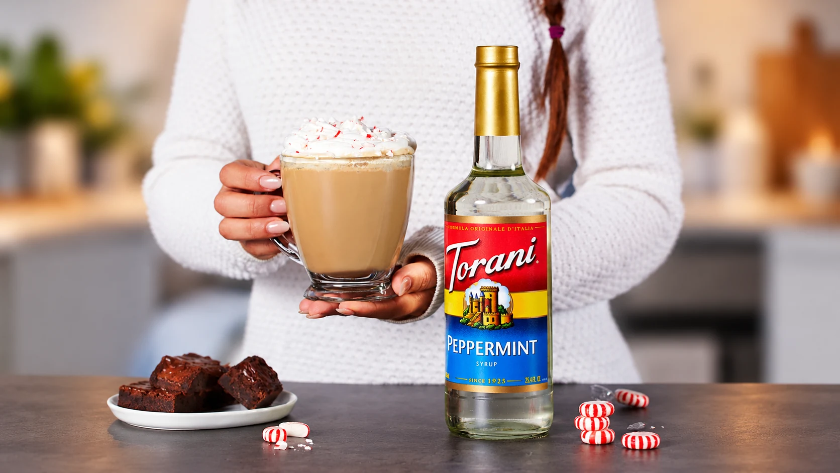 A peppermint bark mocha held beside Torani Peppermint. One bottle is pictured; the linked pack contains four.