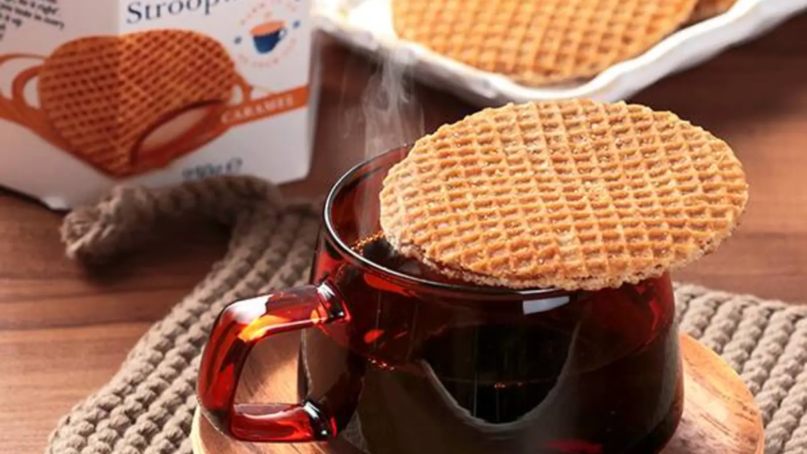 Daelmans caramel stroopwafels arranged with coffee on a rustic table