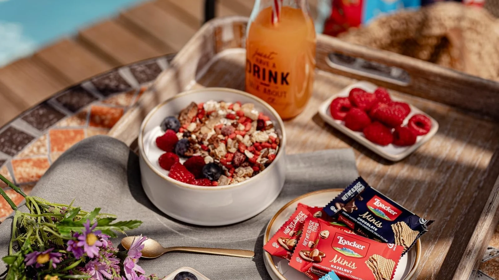 Loacker Mini Wafers arranged with berries, breakfast bowls, and drinks