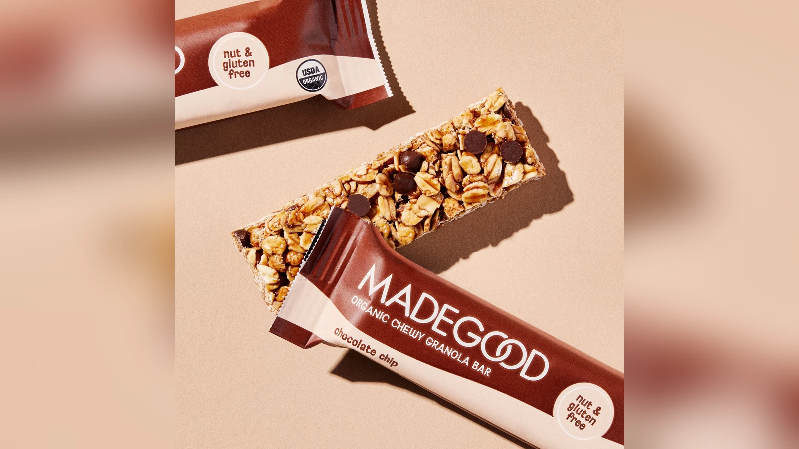 MadeGood chocolate chip granola bar partly unwrapped beside its package