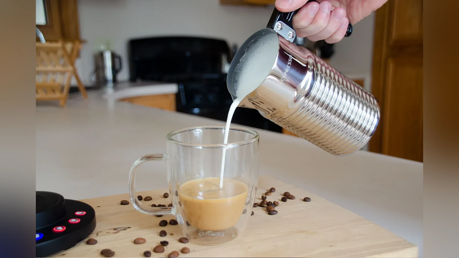 Handled Nespresso Aeroccino4 pouring milk into a cup