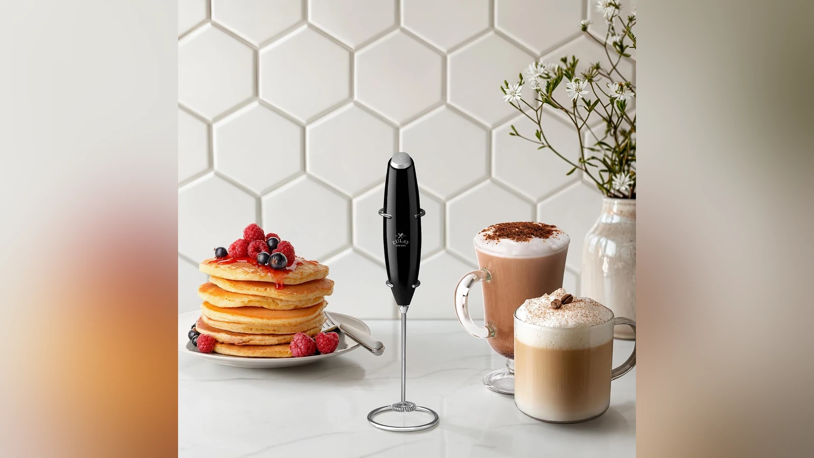 Metallic-black Zulay frother on its stand beside pancakes and coffee
