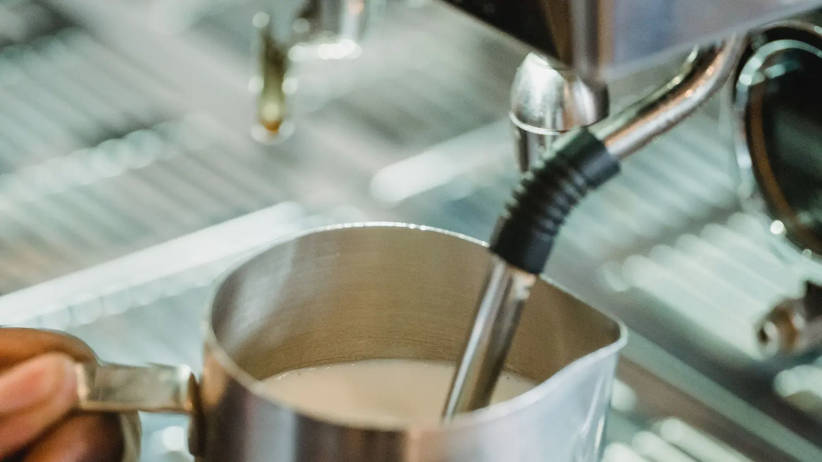 Milk being frothed for a home latte