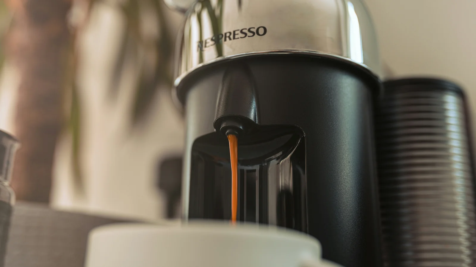 A chrome Nespresso Vertuo brewing coffee into a ceramic mug; photo by Studio 74