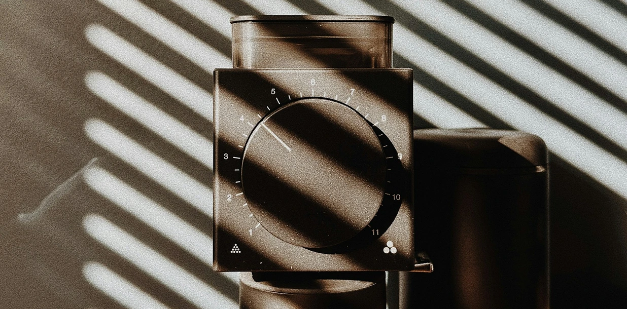 Lineup of compact home espresso grinders on a kitchen counter
