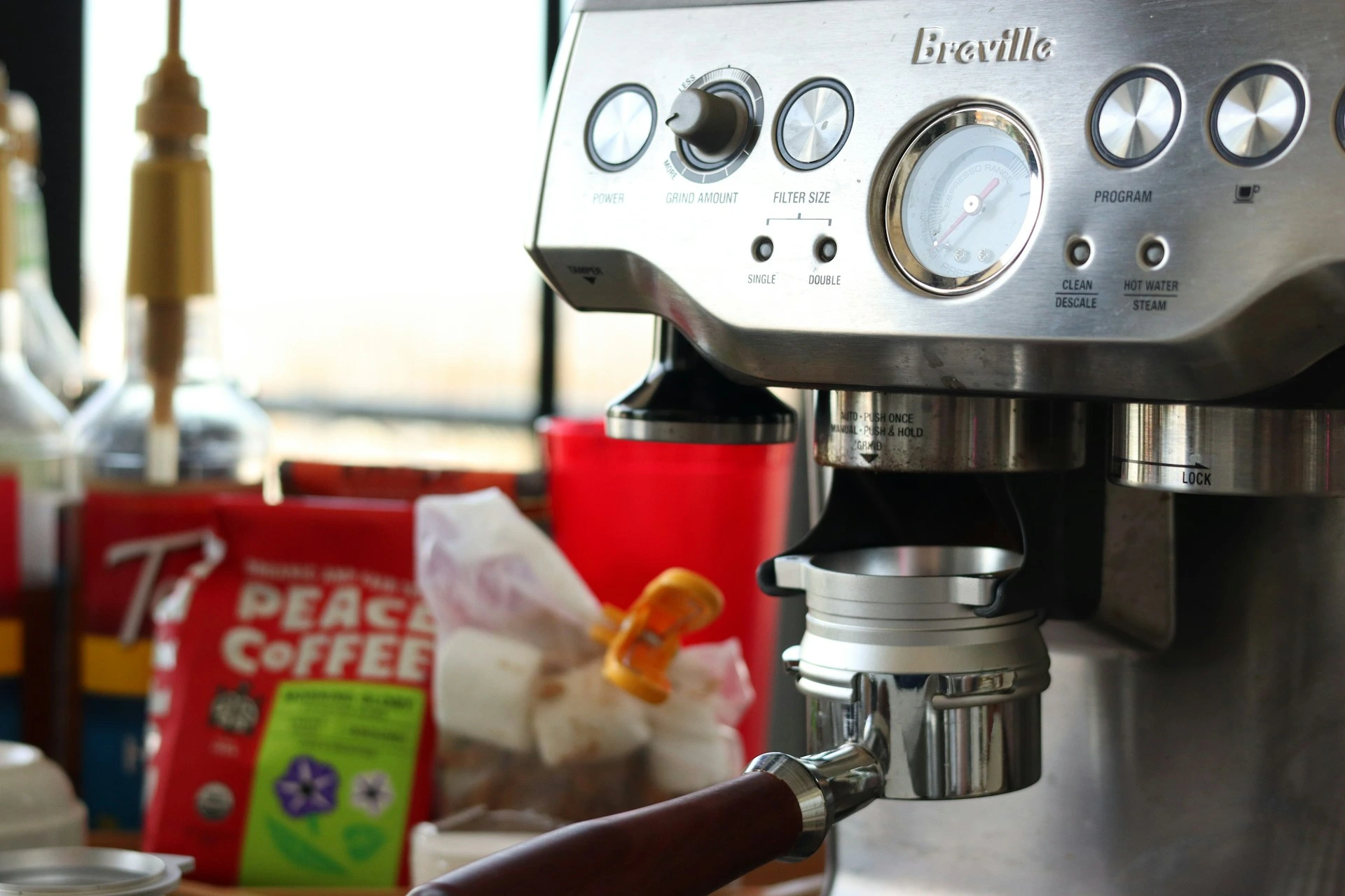 All-in-one espresso machine with built-in grinder on a modern kitchen counter