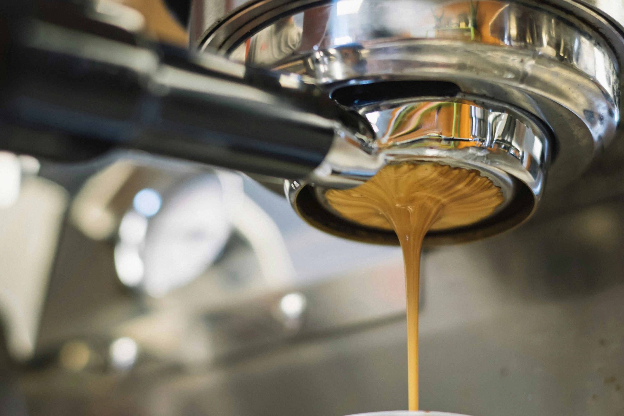 Close-up of espresso flowing from a portafilter during extraction