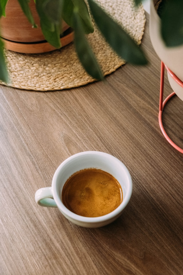 Home barista dialing in espresso shot using a scale and grinder